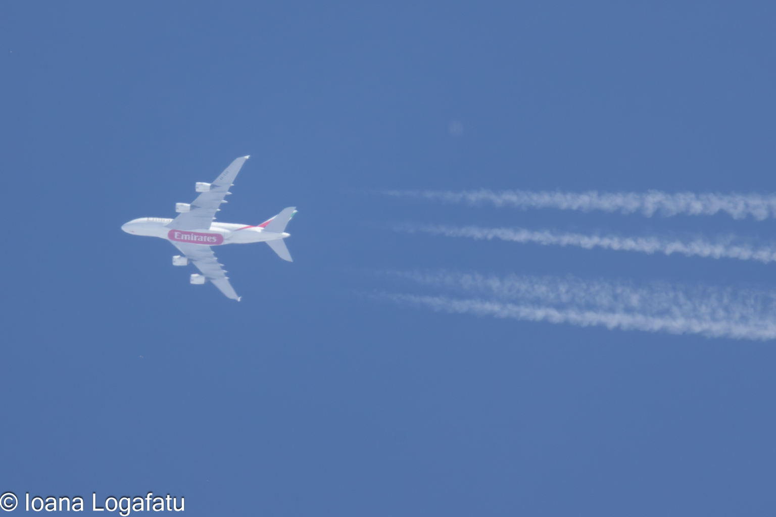 Airplane soaring through a clear blue sky